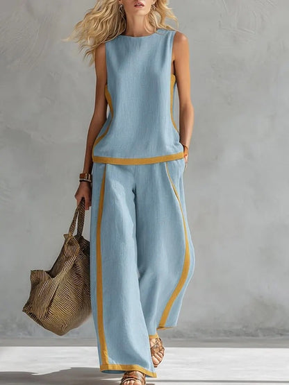 Ensemble décontracté : haut ample sans manches à col rond et pantalon large fluide à taille haute.